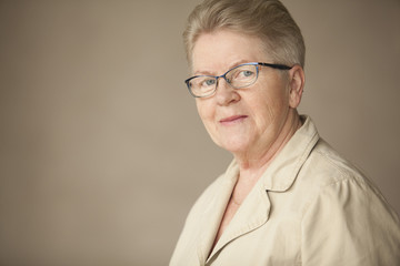 elderly woman smiling and looking at camera