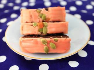 Cake is a piece in a white dish on a point cloth.