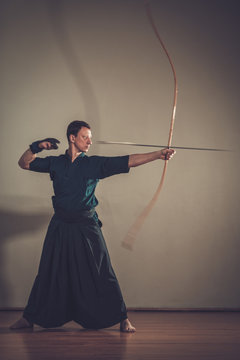Man practicing Kyudo bow shooting.