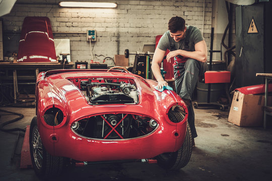 Mechanic Polishning Car In Restoration Workshop