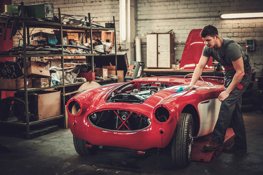 Mechanic Polishning Car In Restoration Workshop