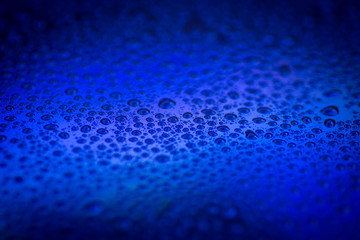 closeup to water drops on glass with lighting background