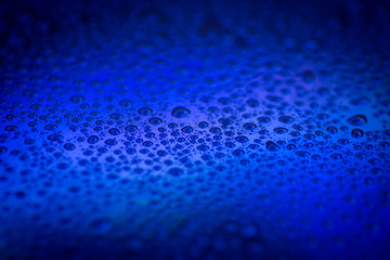 closeup to water drops on glass with lighting background