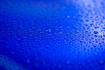 closeup to water drops on glass with lighting background