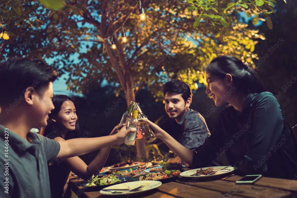 Wall mural people in asian are celebrating the festival they clink beer and dinner outdoor they are happy