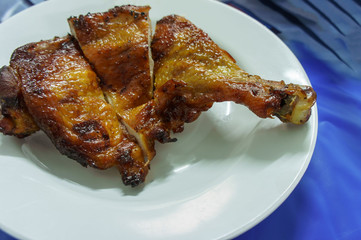 Grilled chicken BBQ (roaster chicken) on white dish. For food.