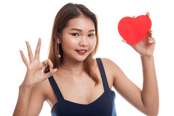 Asian woman show OK with red heart.