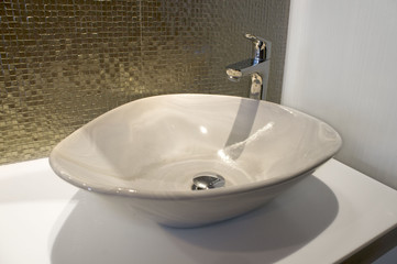 Luxurious  ron sparks green gold mosaic and sink on bathroom at Pattaya, Thailand.