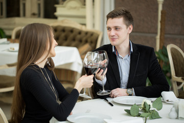 Couple having dinner at a restaurant and making a toast