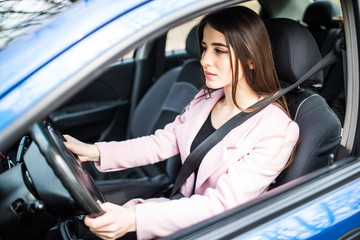 Fototapeta na wymiar Portrait of young woman with fasten seat belt drive her car