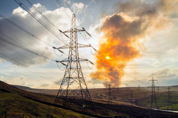 Electric pylons and burning earth