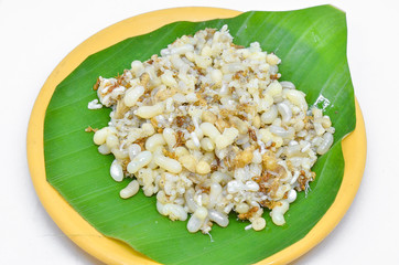 Red ant egg on banana leaf.