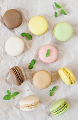Multicoloured macaroons and mint leaves