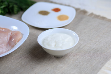 sauce in a plate, mayonnaise in a plate, home-made sauce, sauce Caesar, a lemon, greens