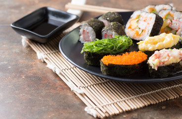 seaweed sushi on black dish and table background,