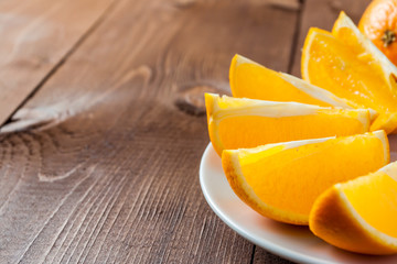 The orange and orange slices on the plate.