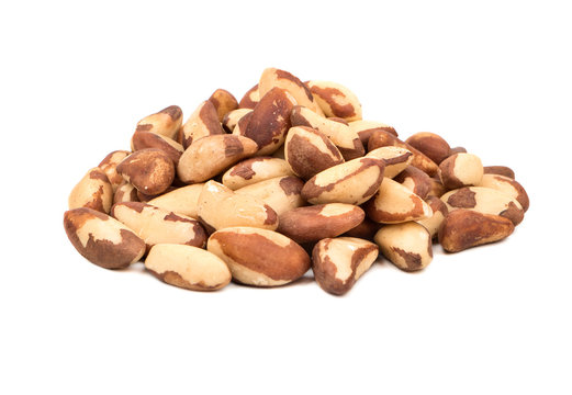 Large pile of raw Brazil nuts on white background