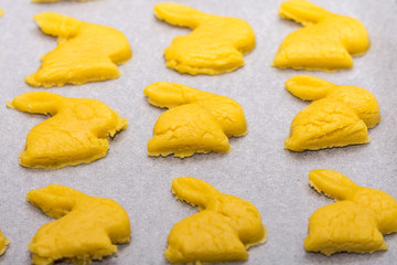 Easter bunnies creating cookies on the table