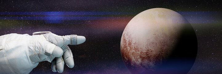 astronaut pointing to dwarf planet Pluto - obrazy, fototapety, plakaty
