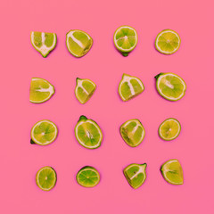 Limes on a pink background. Minimal idea food creative