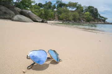 Fototapeta na wymiar Sunglasses on the tropical beach sand