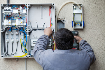 Electrician fixing a fuse