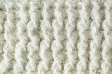 Knit texture of white wool knitted fabric with cable pattern as background