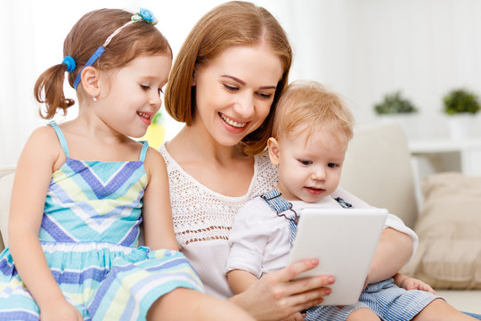 Mother and children with a tablet computer at home