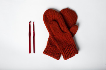 knitted gloves in red on a white background
