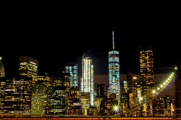 new york skyscraper night view from brooklyn bridge