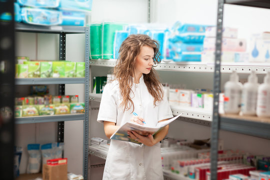 Pharmacist in the storage facility making an inspection. Healthcare business