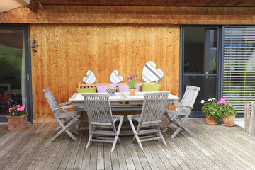 Teak furniture on a wooden terrace