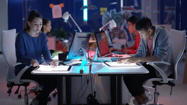  Young Asian video game developers working together on a project