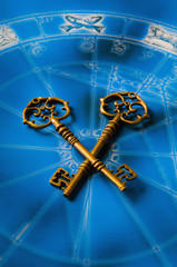 key lying on blue  horoscope with zodiac symbols like a concept astrology and success, key to...