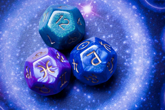 three astrology cubes with astrological symbols over a blue backround with magic circle 
