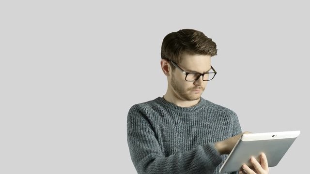 Clever hipster creative man think touch digital tablet ipad gets an idea, which jumps up as symbolic colored cartoon animation shape lamps around him on white background