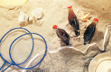 Bottles of cool drink with items for beach entertainment