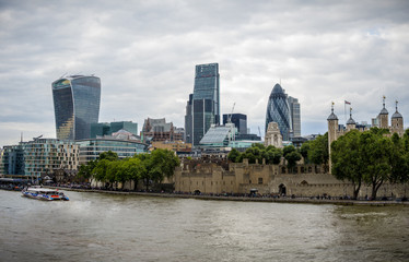 Naklejka premium The tower of London and skyscrapers in the City as seen from Tower Bridge