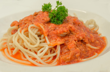 Spaghetti italian pasta with tomato sauce bolognese and fresh basil. Closeup.