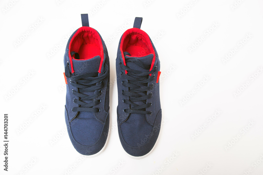 Wall mural blue sneakers on isolated white background