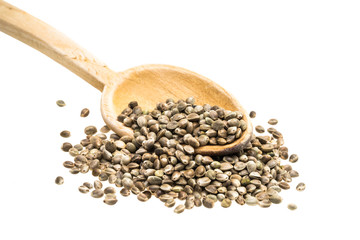 Hemp seeds on a wooden spoon slanted from the left on white background