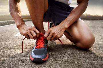 Man tying running shoes