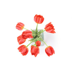 Red tulips in a vase isolated on a white background, top view