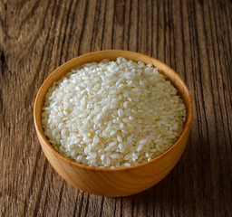 rice in  bowl on wooden surface