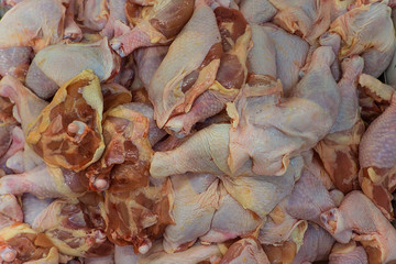 Closeup of raw chicken drumsticks.