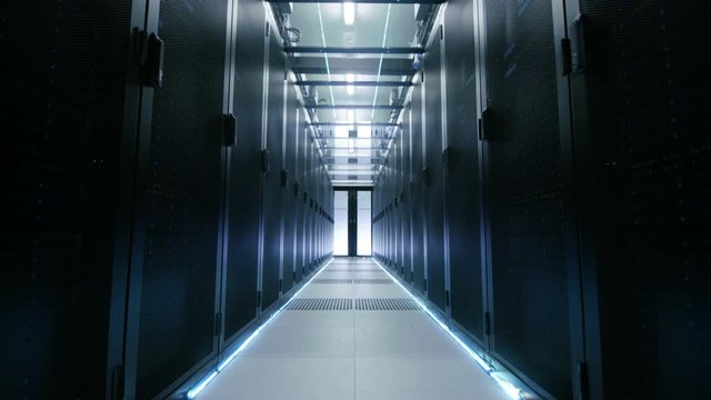 Camera Moves Through Opening Sliding Doors Into Big Modern Data Center. Rows of Working Rack Servers Flash with LED Lights.  Shot on RED EPIC-W 8K Helium Cinema Camera.