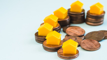 Obraz na płótnie Canvas Miniature house on 1 Cent coin stacks, real estate and finance concept
