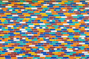 Colorful wall of bricks painted in various colors