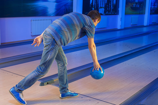 a man throws a bowling ball