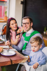family and friends in cafe pizzeria shop